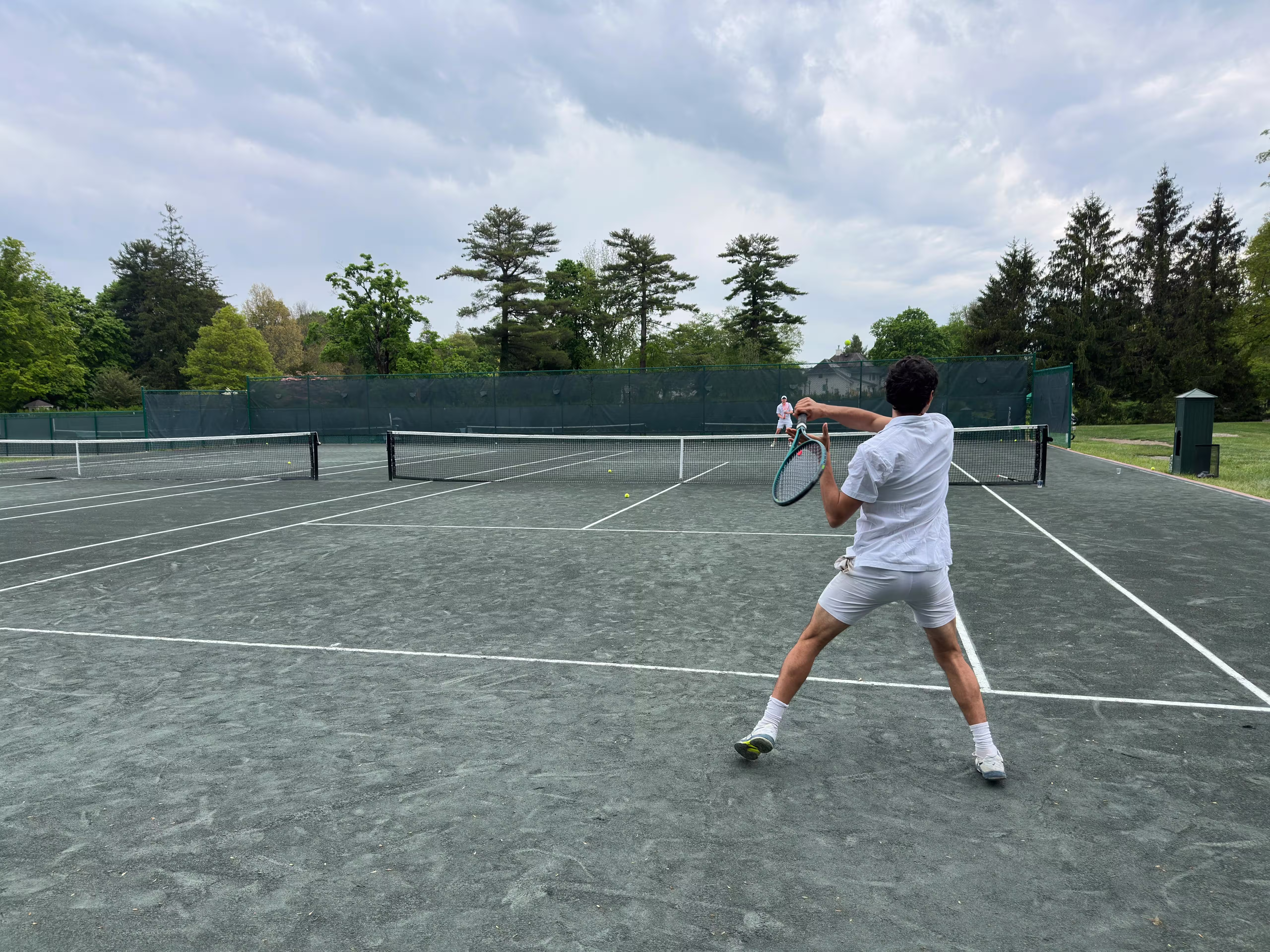 Leonardo Noli, private tennis coach, hitting a forehand on a Connecticut home court